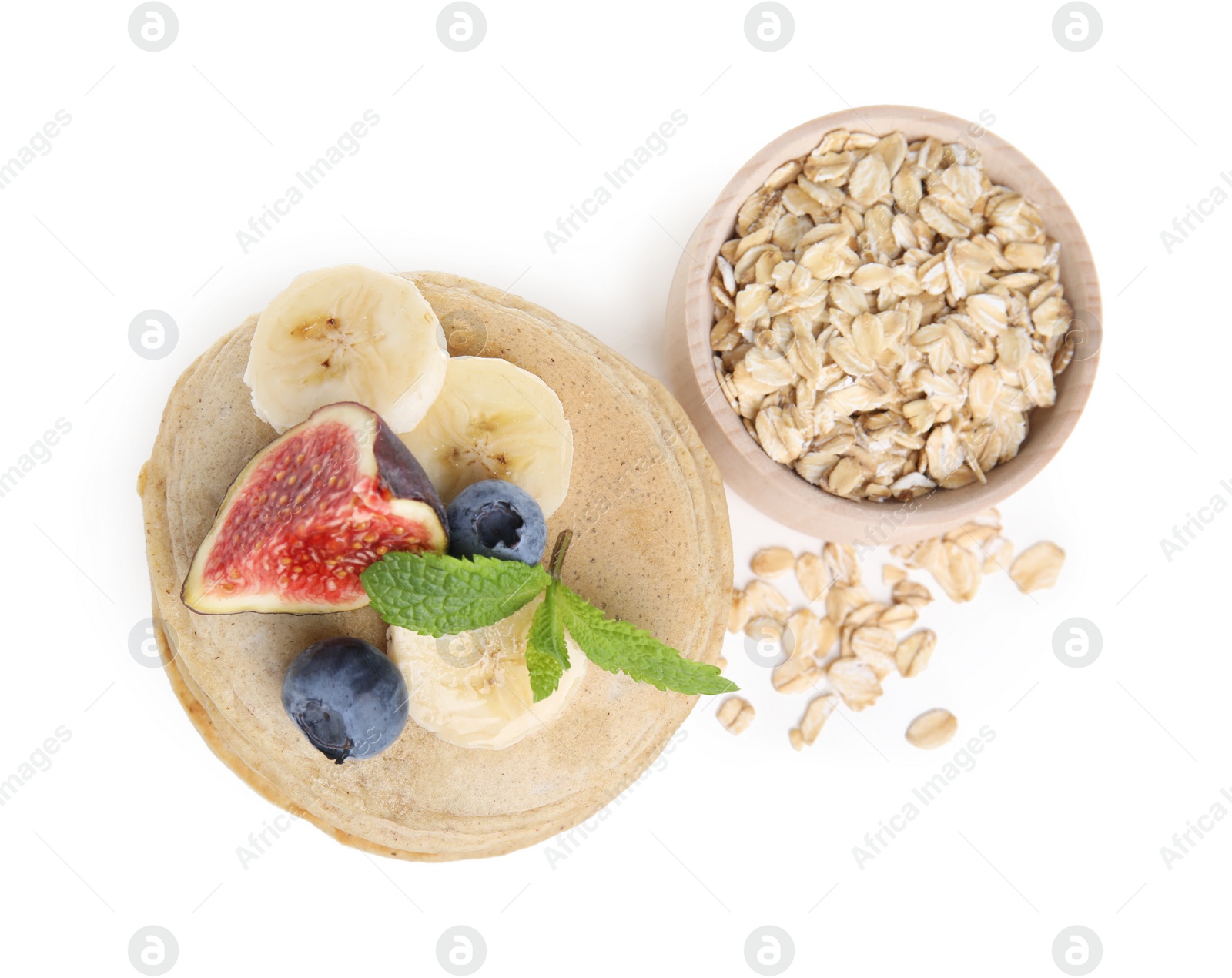 Photo of Tasty oatmeal pancakes and ingredients on white background, top view