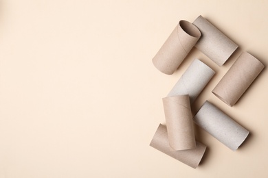 Photo of Flat lay composition with empty toilet paper rolls and space for text on color background