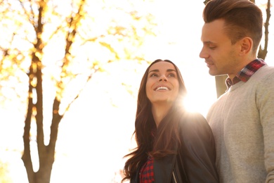 Photo of Happy couple in sunny park. Autumn walk