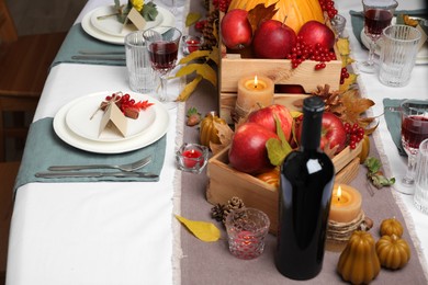 Photo of Beautiful autumn place setting and decor on table in room