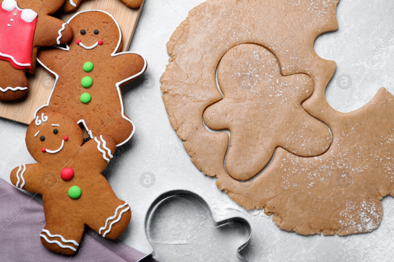 Photo of Flat lay composition with homemade gingerbread man cookies on light grey table