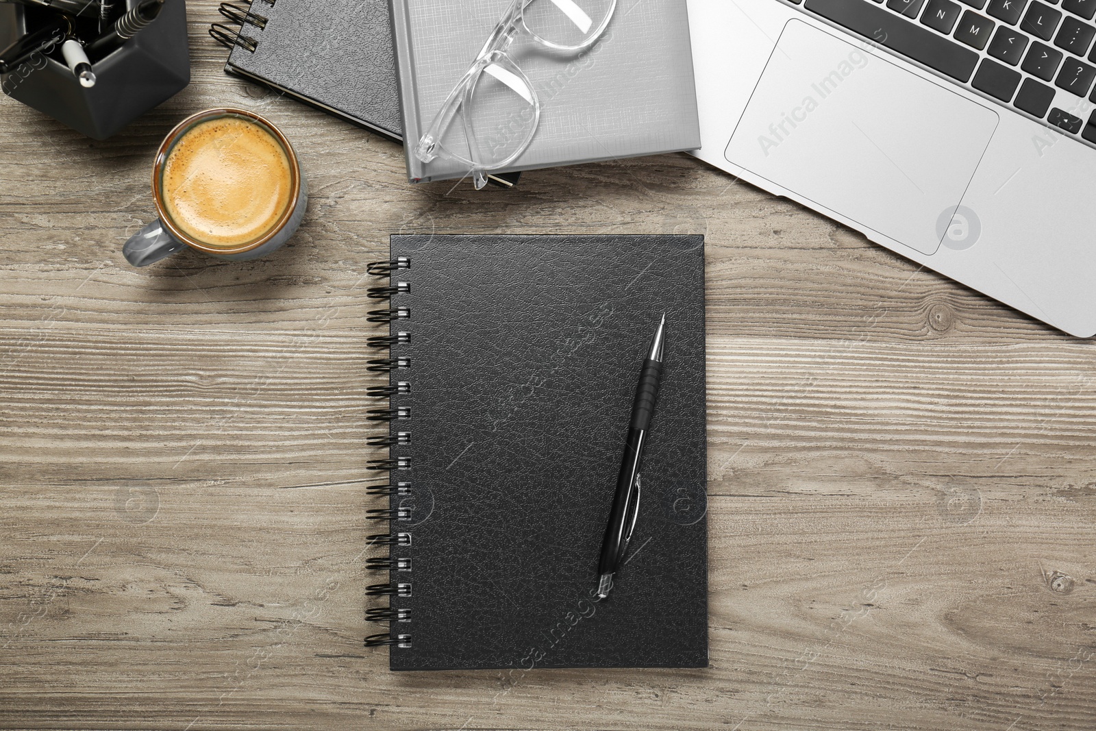 Photo of Flat lay composition with notebooks and laptop on wooden table