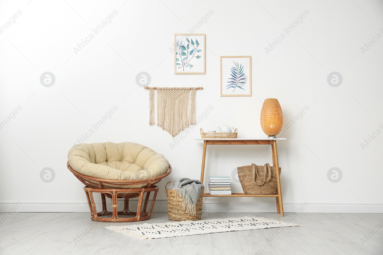 Photo of Living room interior design with comfortable papasan chair and wooden table