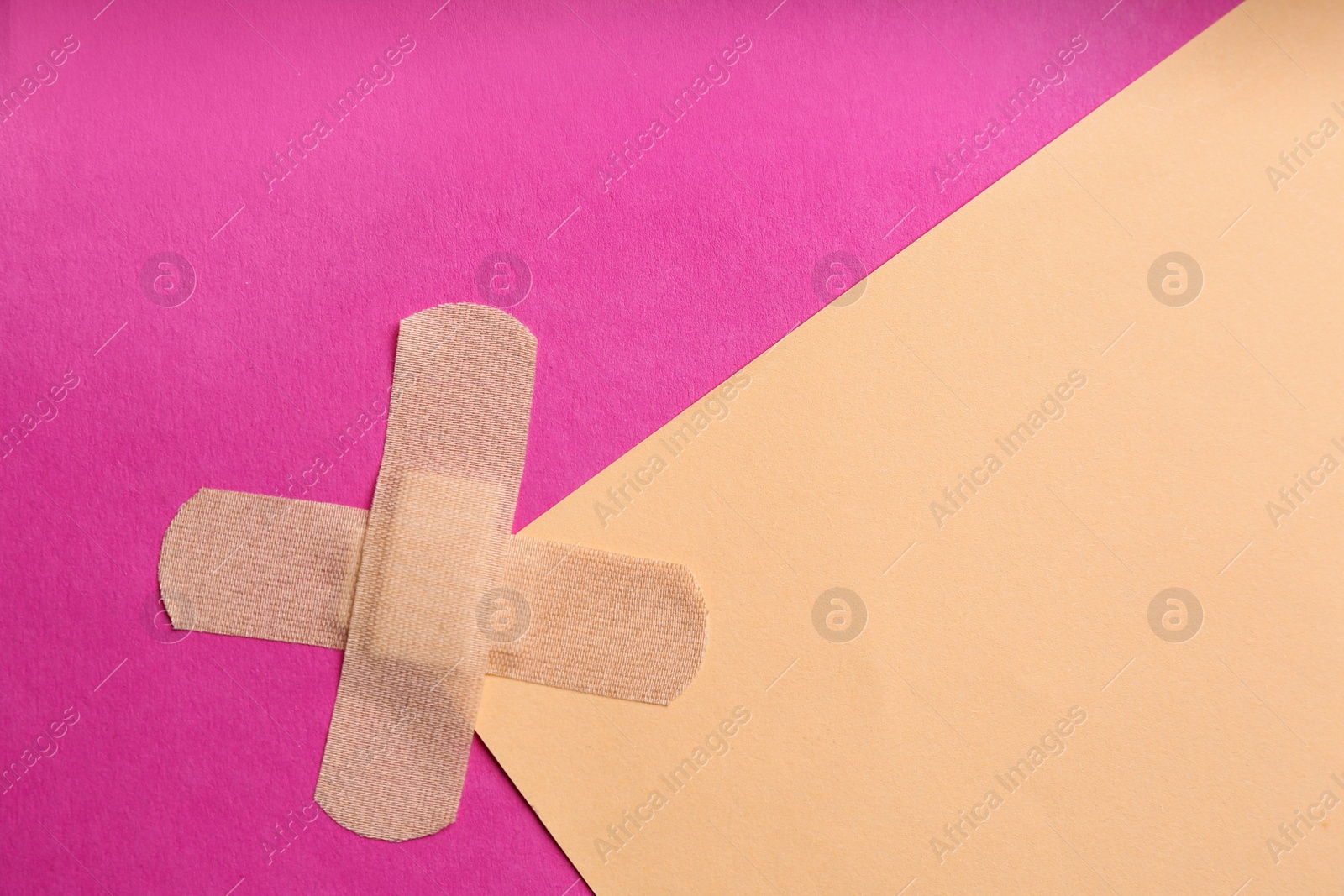 Photo of Sticking plasters on color background, top view. Space for text