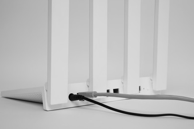 One modern Wi-Fi router on white background, closeup