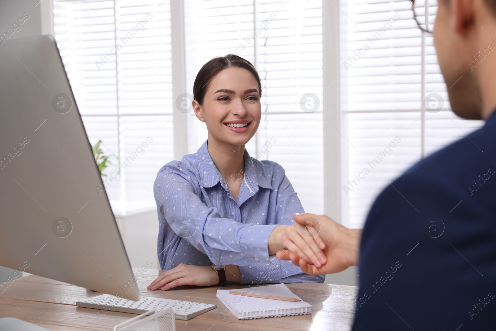 Photo of Man shaking hands with intern in office