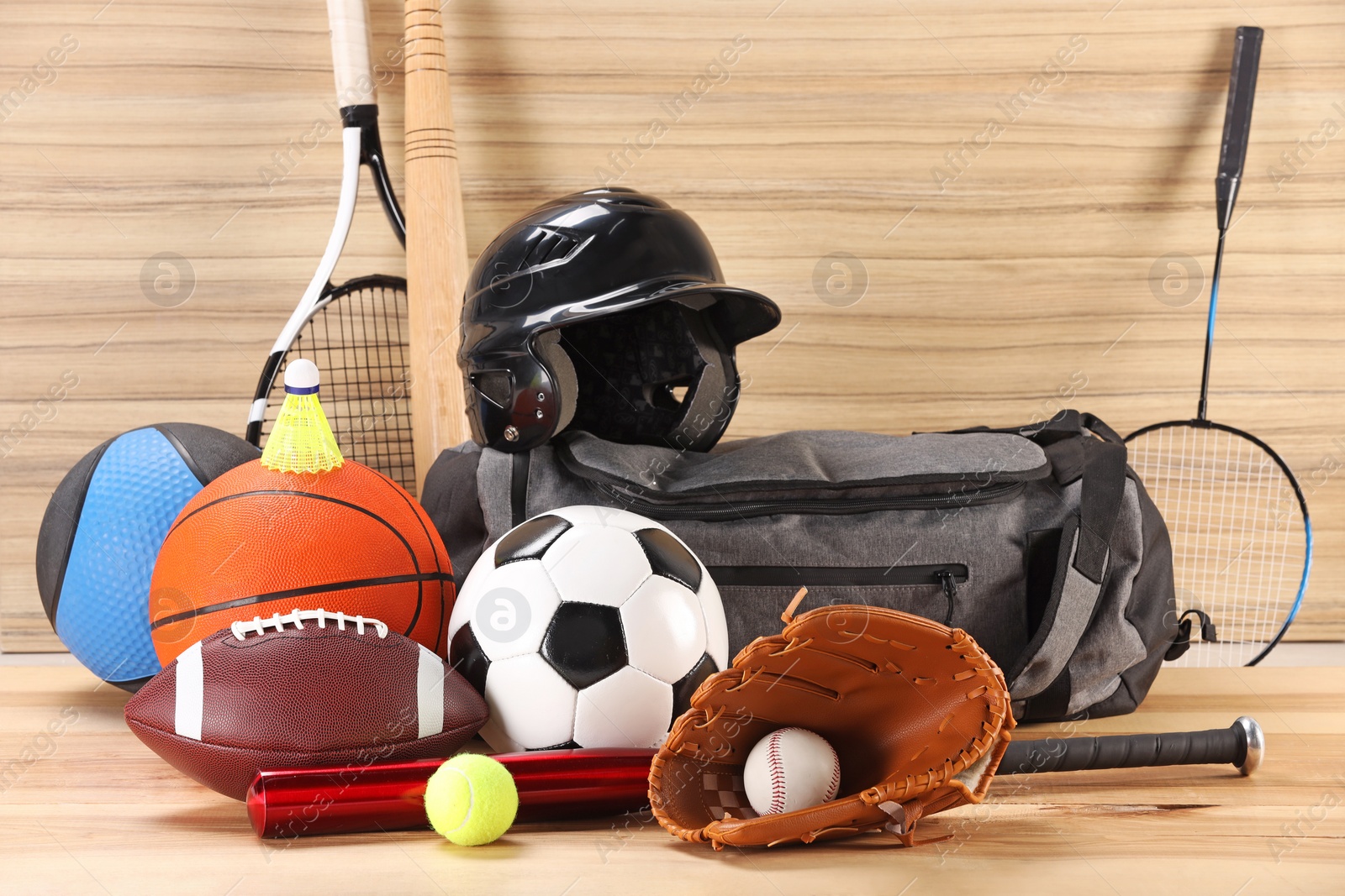 Photo of Many different sports equipment on wooden table