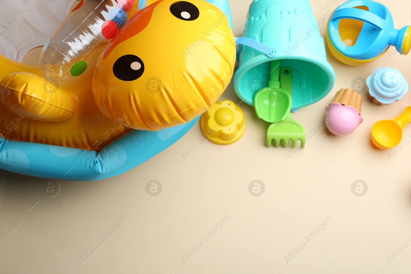 Photo of Flat lay composition with bright beach toys on color background. Space for text