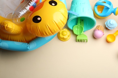 Photo of Flat lay composition with bright beach toys on color background. Space for text