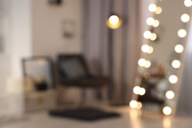 Blurred view of makeup room with stylish mirror