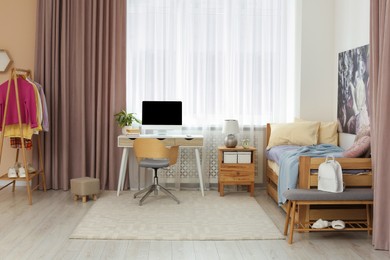 Stylish teenager's room interior with computer and comfortable bed