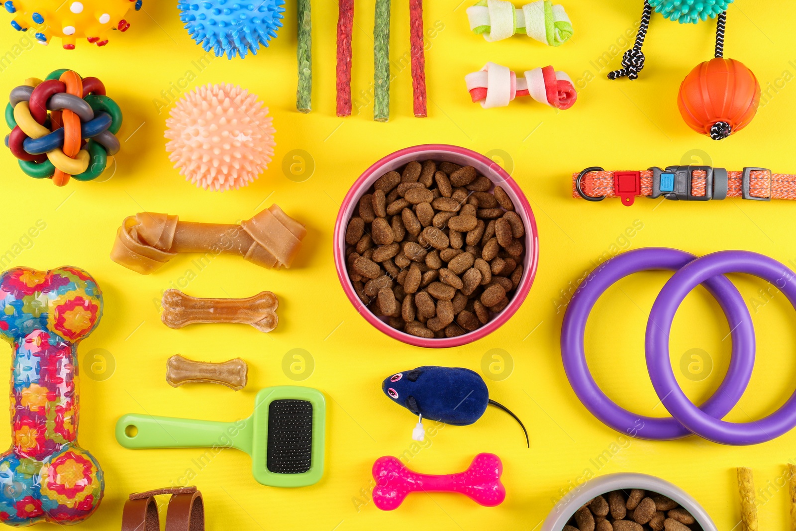 Photo of Flat lay composition with different pet goods on yellow background. Shop assortment