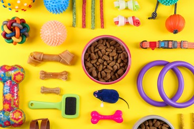 Photo of Flat lay composition with different pet goods on yellow background. Shop assortment