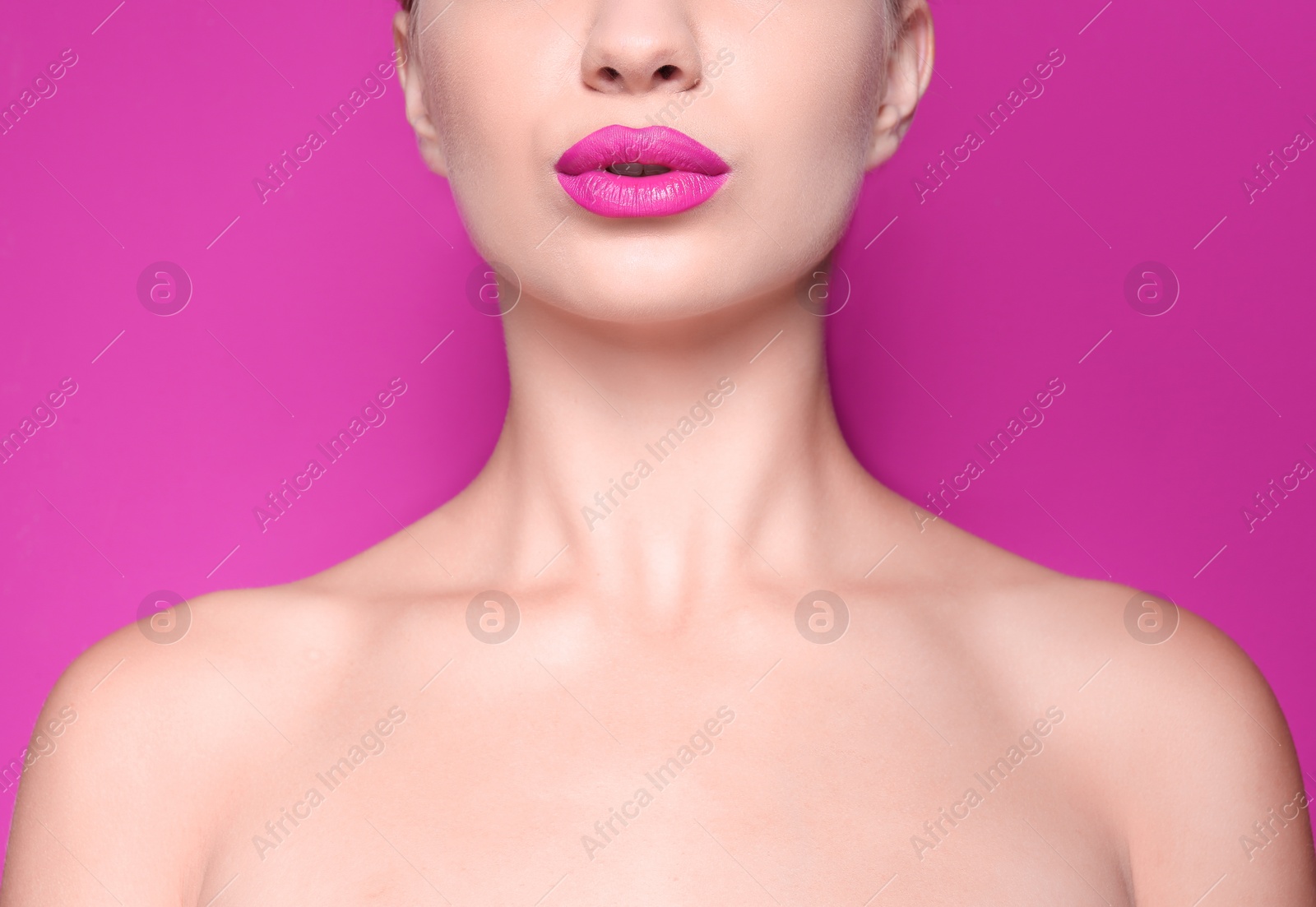 Photo of Beautiful young woman with perfect lips makeup on color background, closeup