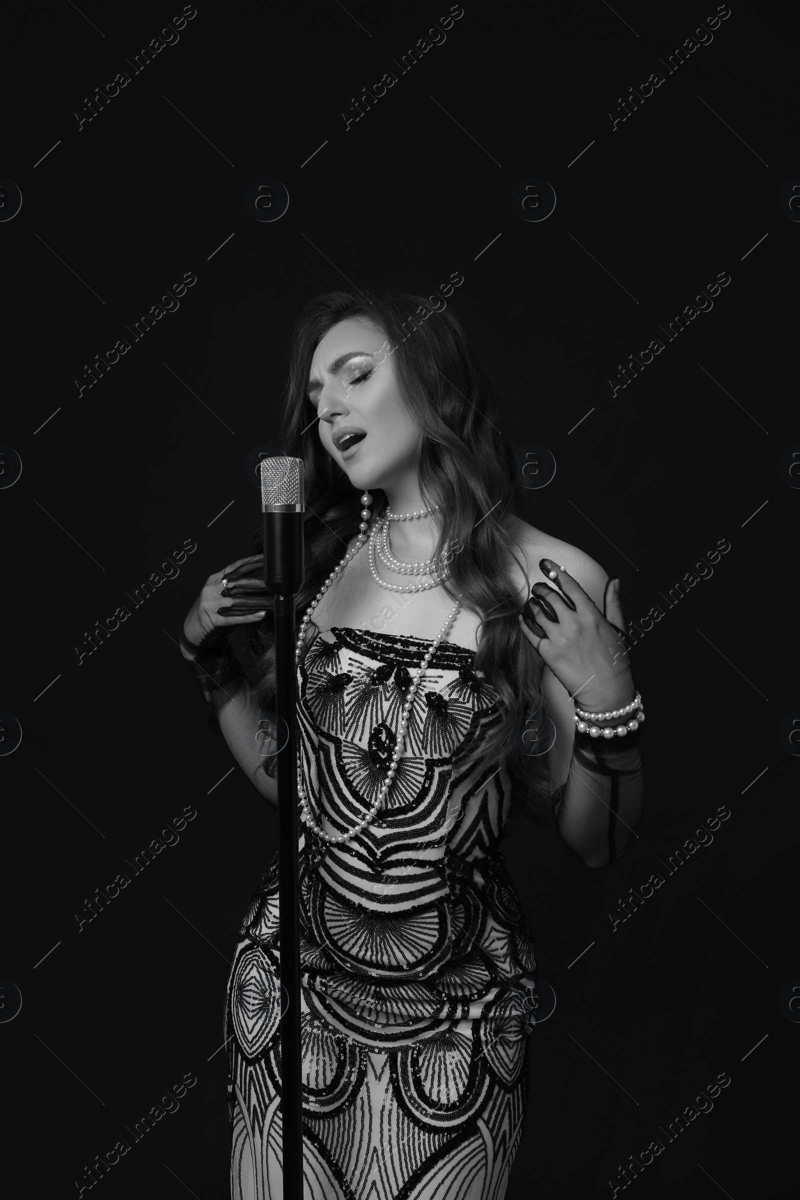 Image of Beautiful singer with microphone, black and white effect