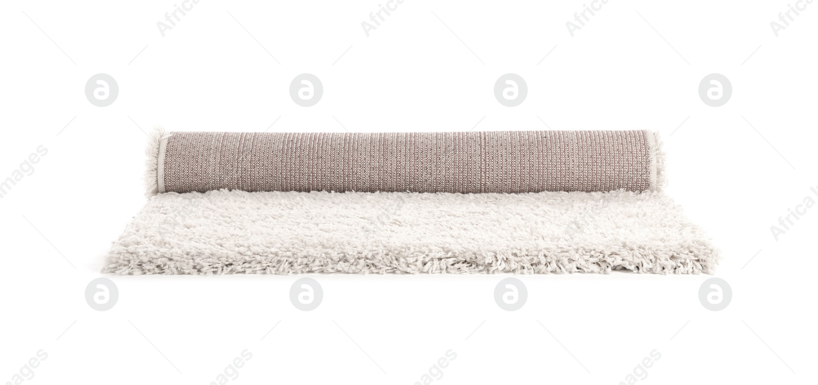 Photo of Rolled fuzzy carpet on white background. Interior element