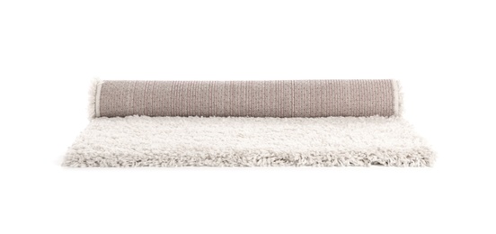 Photo of Rolled fuzzy carpet on white background. Interior element