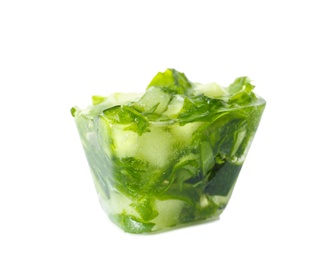 Photo of Ice cube with cucumber slices and herbs on white background