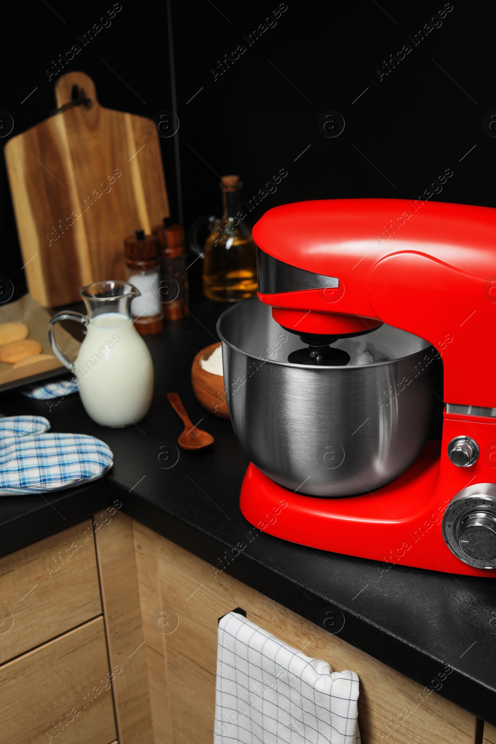 Photo of Modern red stand mixer and ingredients on countertop in kitchen