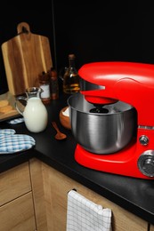 Photo of Modern red stand mixer and ingredients on countertop in kitchen