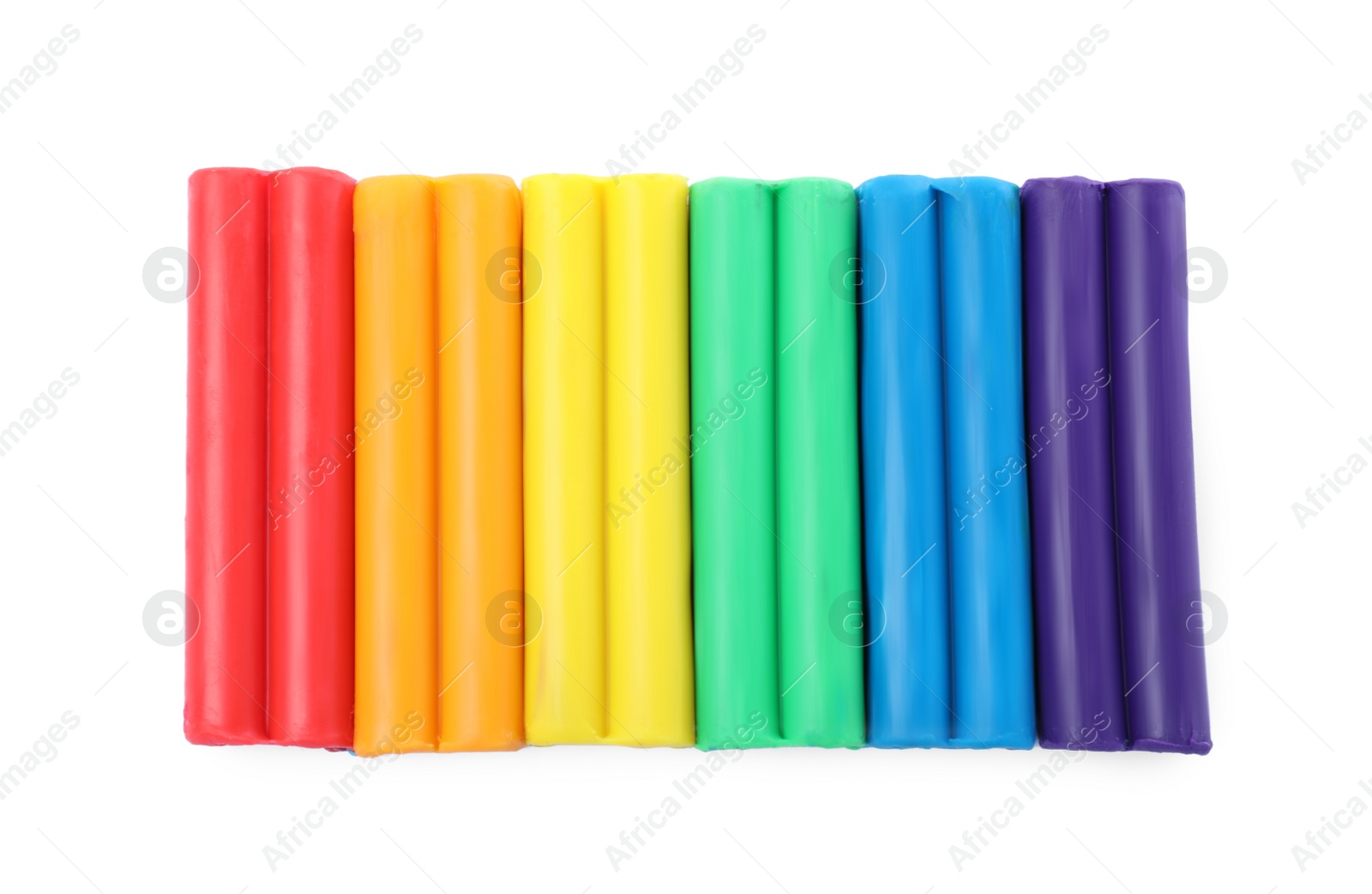 Photo of Many different colorful plasticine pieces on white background, top view