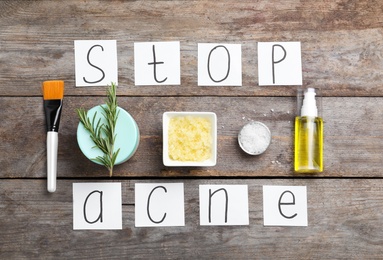 Photo of Phrase "Stop acne" and ingredients for homemade problem skin remedy on wooden background