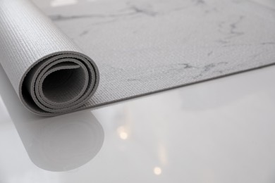 Karemat or fitness mat on floor indoors, closeup. Space for text