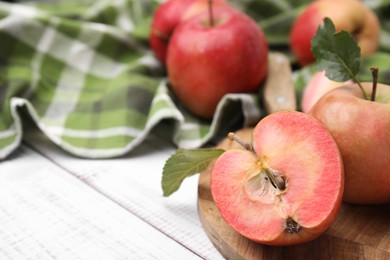 Tasty apples with red pulp on white wooden table, closeup. Space for text