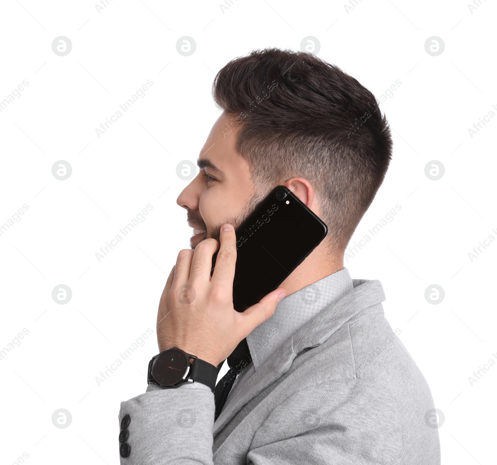 Photo of Young businessman talking on smartphone against white background