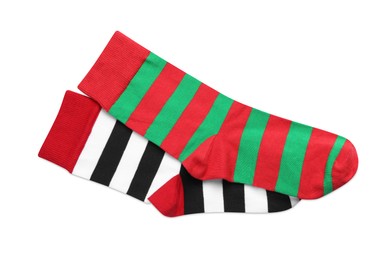 Photo of Different striped socks on white background, top view