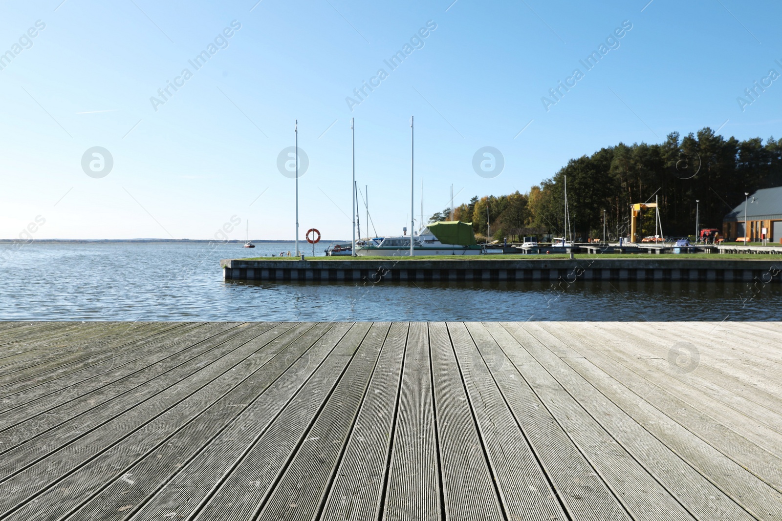 Photo of Beautiful view of wooden terrace near river on sunny day