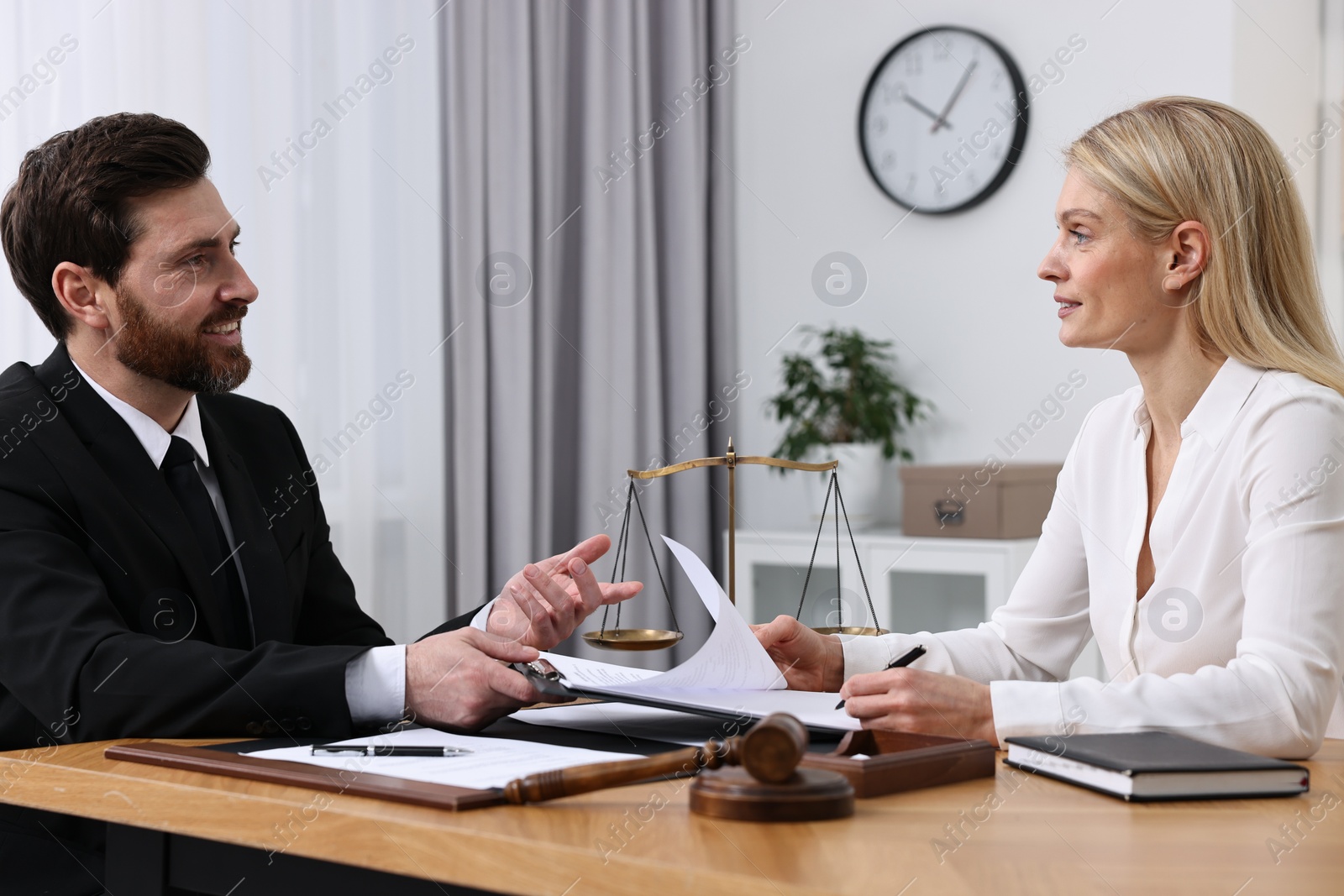 Photo of Woman having meeting with lawyer in office