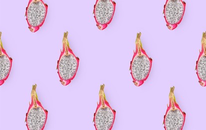 Cut delicious exotic dragon fruits on lilac background, flat lay