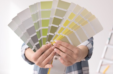 Photo of Woman with color palette on white background, closeup