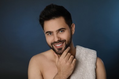Handsome young man with beard after shaving on blue background
