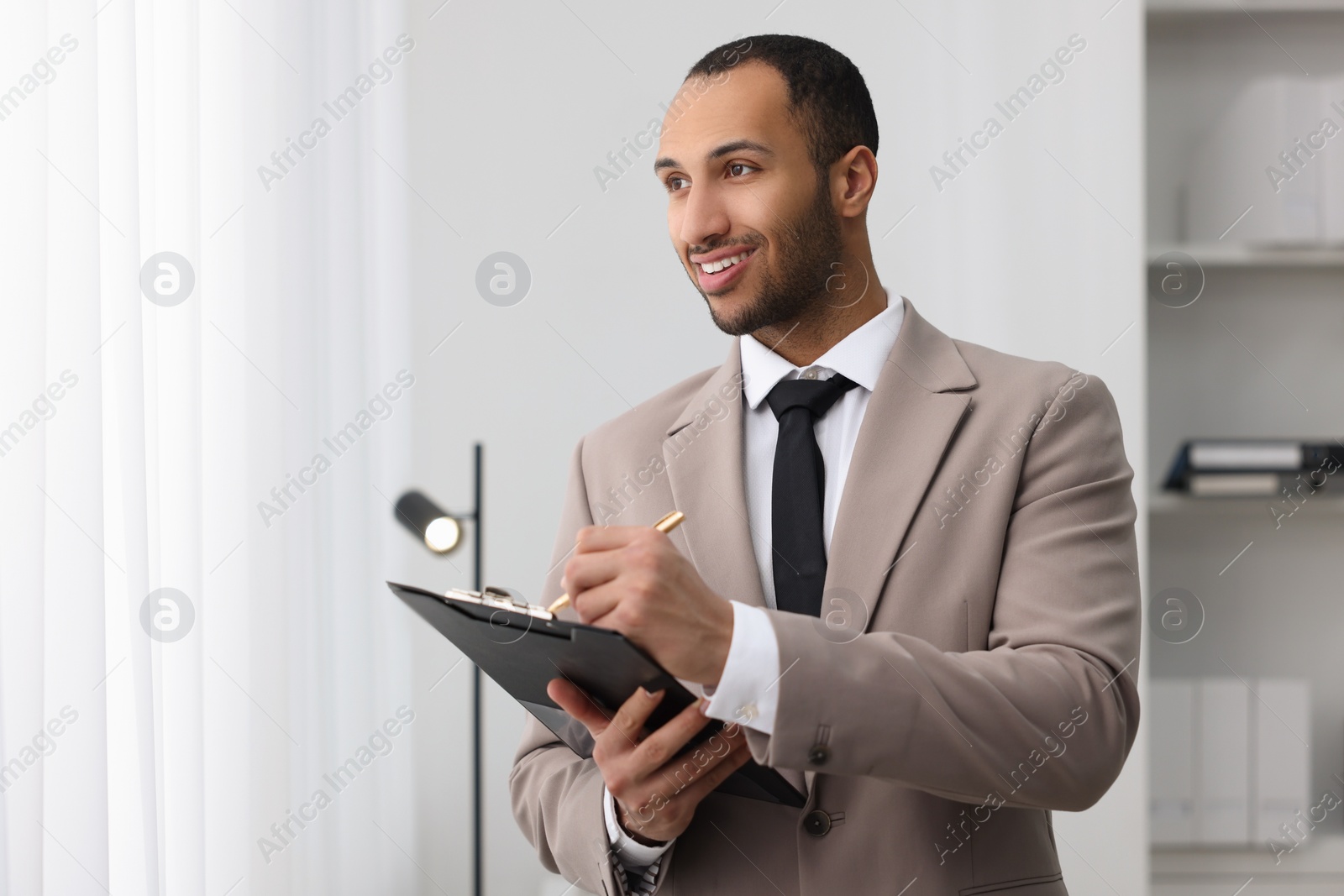 Photo of Smiling young man in office, space for text. Lawyer, businessman, accountant or manager