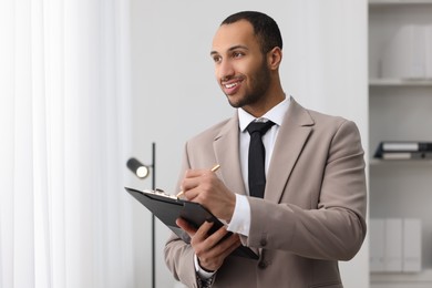 Smiling young man in office, space for text. Lawyer, businessman, accountant or manager