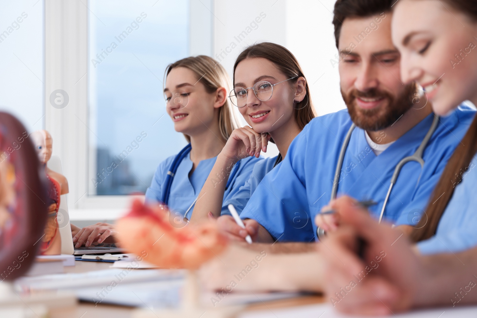 Photo of Medical students in uniforms studying at university