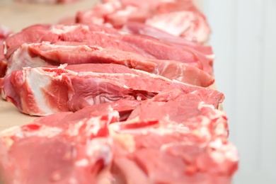 Photo of Pieces of fresh raw meat on counter in butcher shop