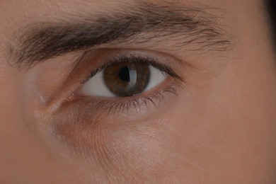 Photo of Evil eye. Man with scary eyes, closeup view
