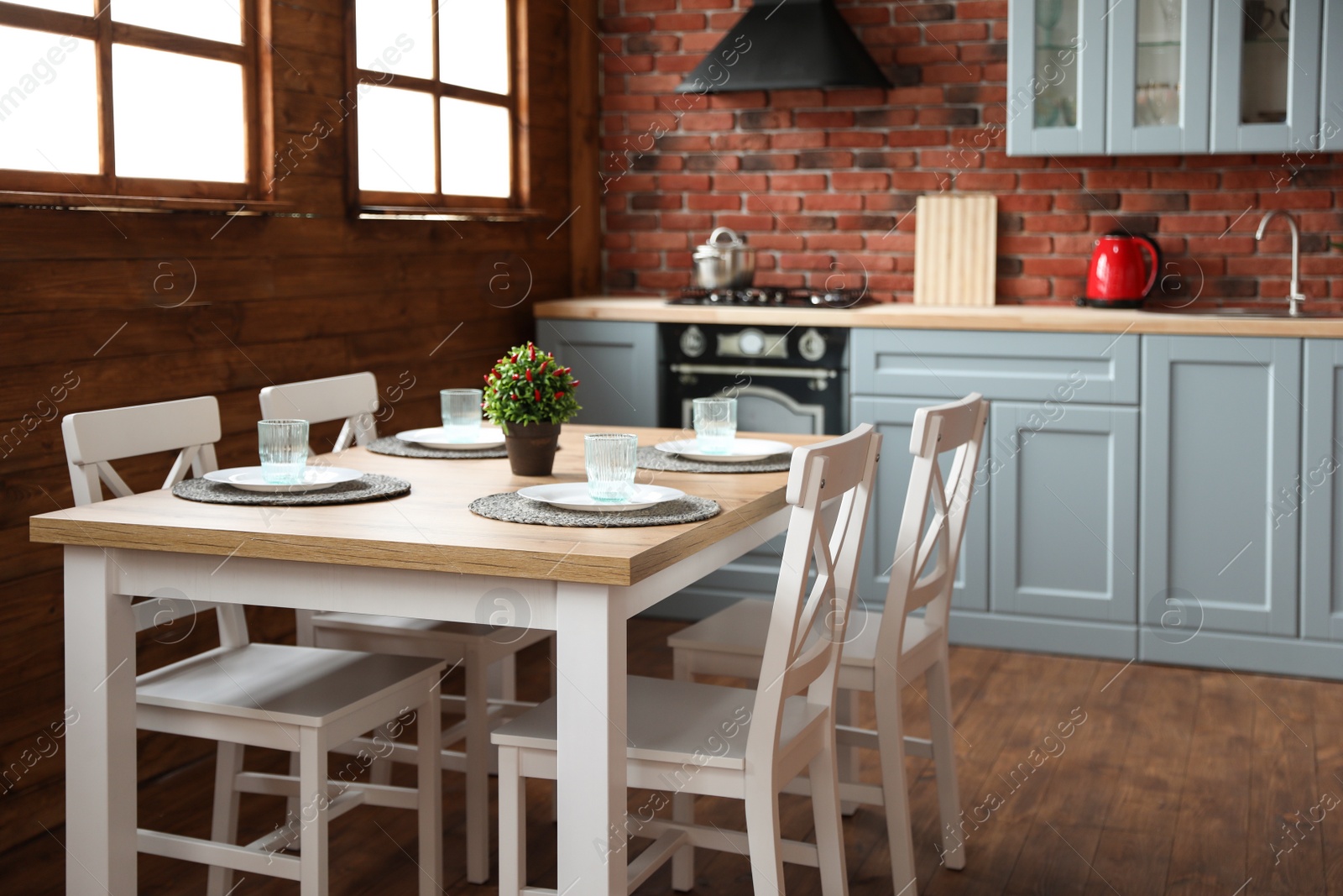 Photo of Stylish kitchen interior with dining table and chairs