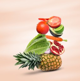 Stack of different vegetables and fruits on beige background