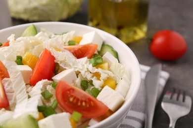 Tasty salad with Chinese cabbage, cheese, pepper, tomato and green onion on table, closeup