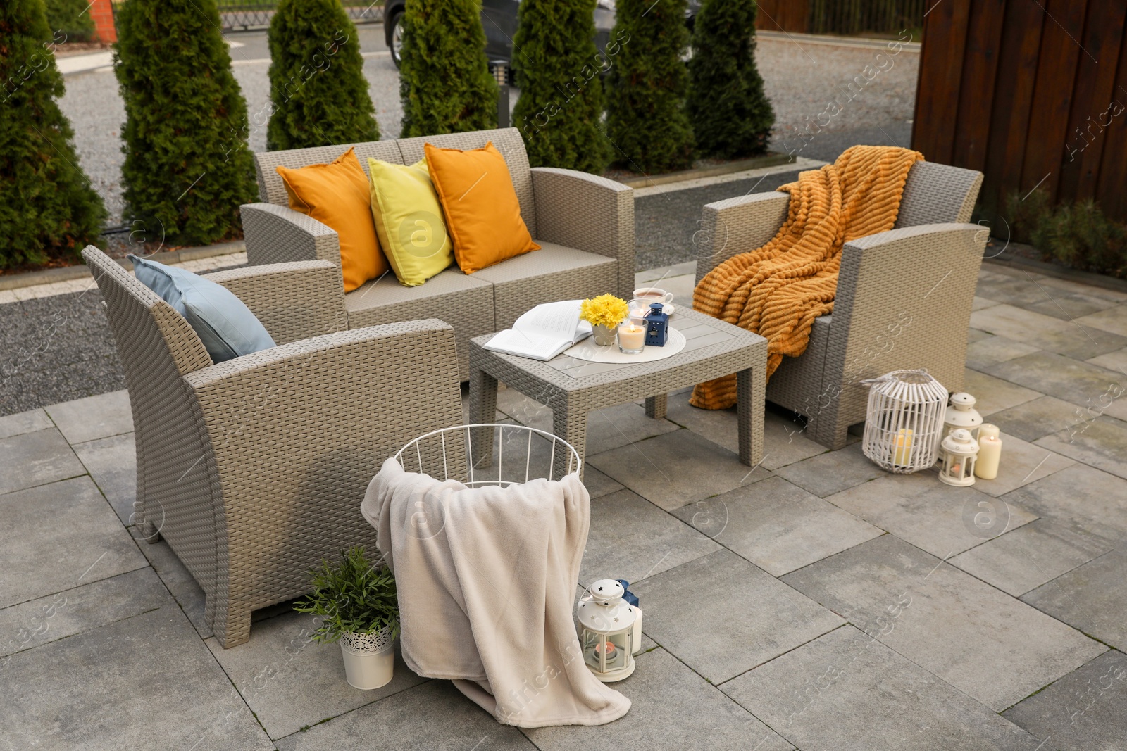 Photo of Beautiful rattan garden furniture, soft pillows and different decor elements outdoors