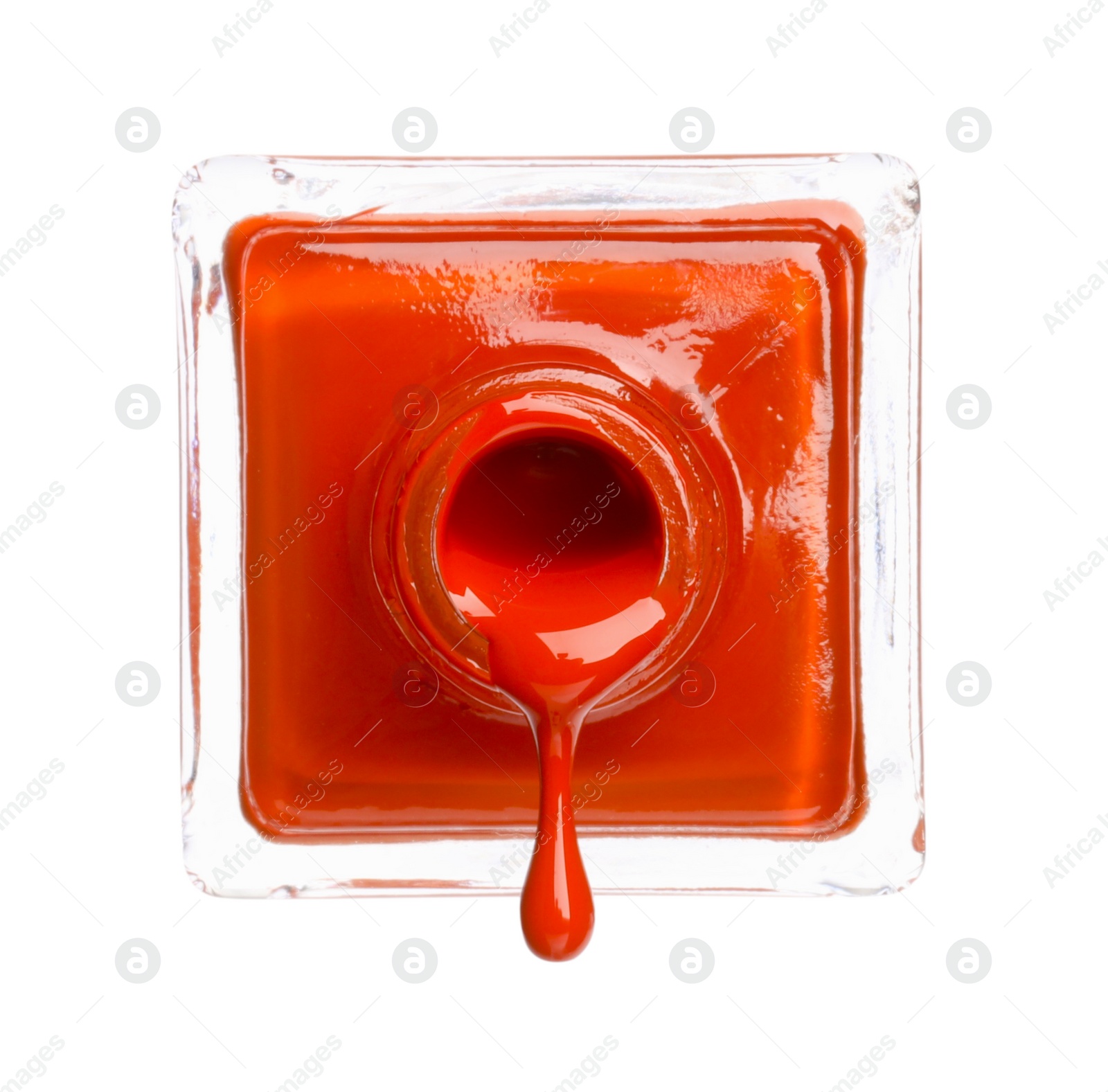 Photo of Orange nail polish dripping from bottle isolated on white