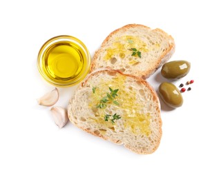 Photo of Tasty bruschettas with oil, garlic and olives on white background, top view