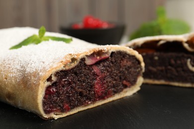 Photo of Delicious strudel with cherries on board, closeup