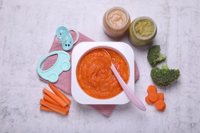 Photo of Flat lay composition with healthy baby food and ingredients on white textured table