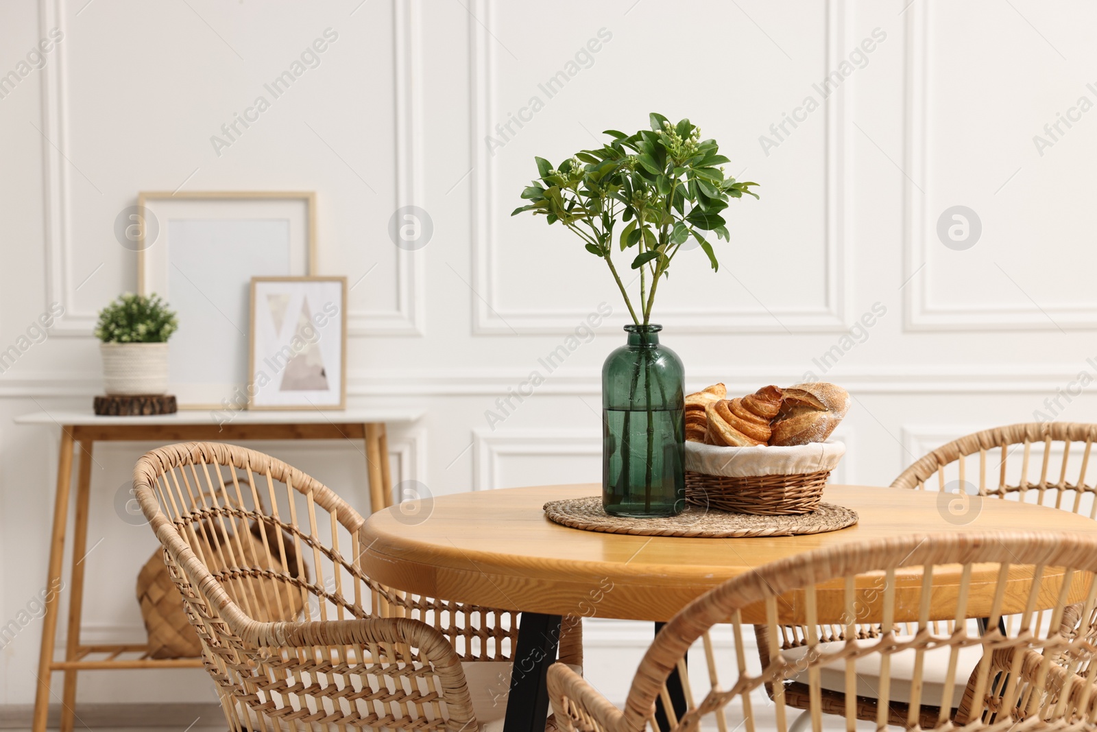 Photo of Dining room interior with comfortable furniture and plants