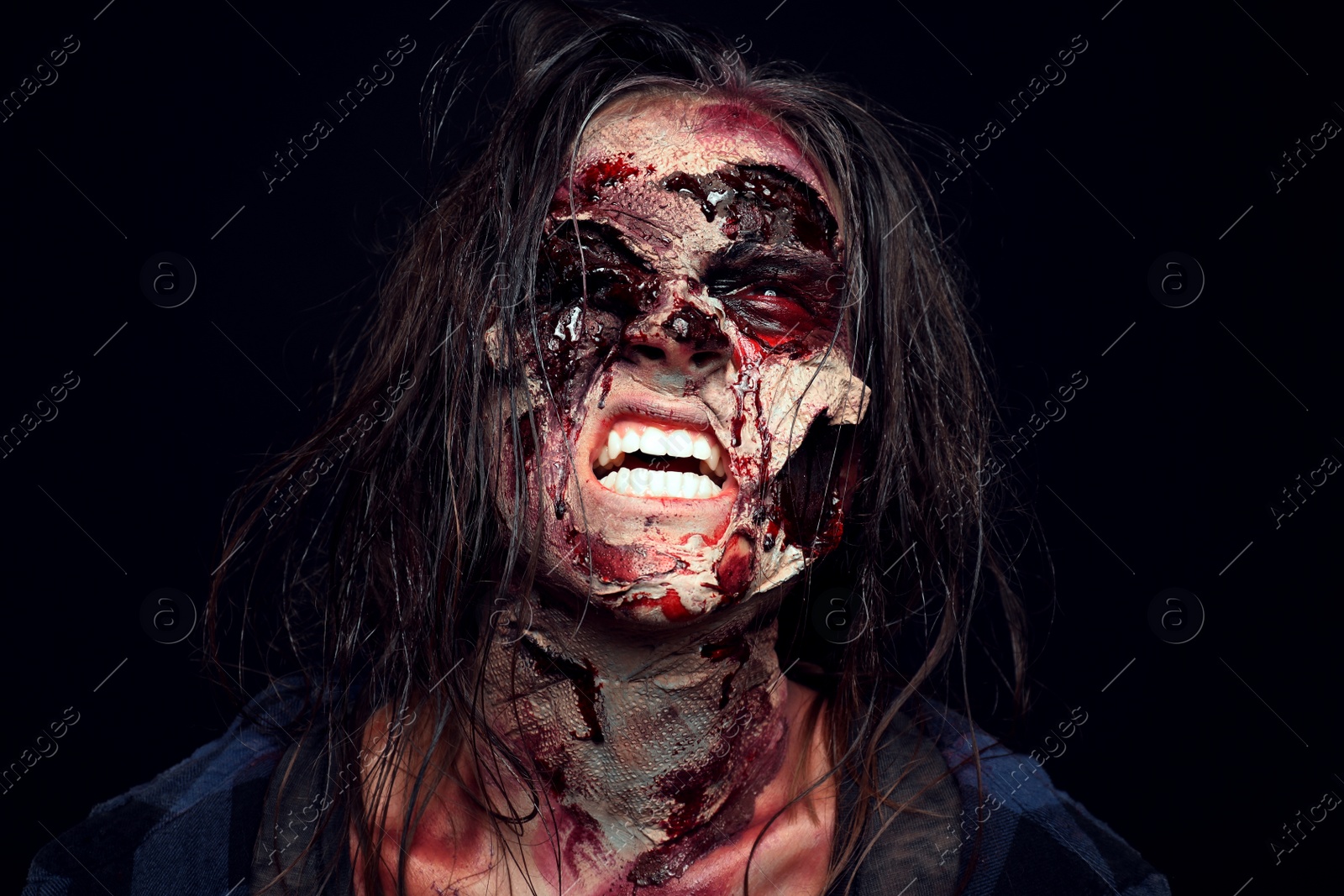 Photo of Scary zombie on dark background. Halloween monster